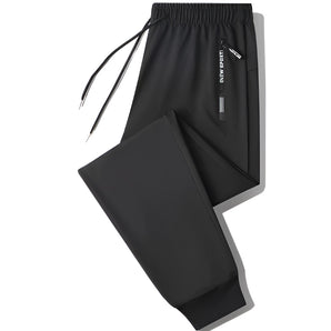 Men's black joggers showcasing lightweight design with zippered pockets, suitable for athletic activities.