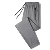 Men's gray joggers in size 4XL, designed as lightweight athletic pants with zippered pockets.