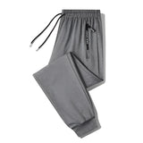 Men's black joggers with zippered pockets, designed as lightweight athletic pants suitable for sports and casual wear.
