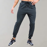 Men's black joggers featuring a comfortable fit and moisture-wicking fabric, designed with functional pockets and suitable for athletic activities.