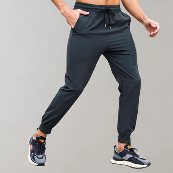 Men's black joggers in XL size, featuring moisture-wicking fabric, side pockets, and designed for athletic activities.