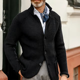 Men's black knit blazer styled as a designer formal cardigan, shown in Nero color and 3XL size. The blazer features a sleek design with a fashion-forward appeal, complemented by a white dress shirt underneath. The image highlights the texture of the knit fabric and the blazer's form-fitting silhouette, including the neckline, sleeves, and waist.