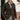 Men's black knit blazer modeled by a bearded man in a formal setting, showcasing the designer cardigan style with a focus on fashion and textile detail.