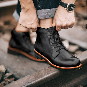 Men's black leather ankle boots featuring a stylish lace-up design and durable rubber sole.