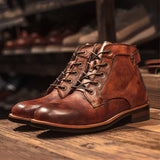 Men's brown leather ankle boots with a stylish lace-up design, rubber sole, and fashion-forward appearance.