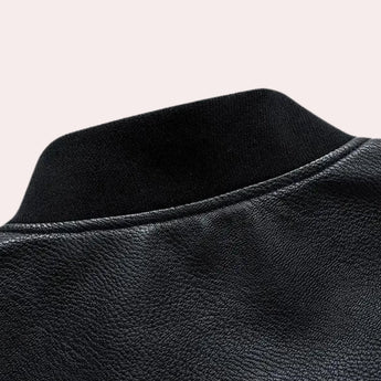 Men's black leather bomber jacket with faux grey sleeves, tailored fit, displayed against a neutral background.