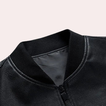 Men's black leather bomber jacket with faux sleeves, featuring a tailored fit, button closure, collar, and pockets.