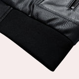 Men's black leather bomber jacket with faux sleeves and a tailored fit, featuring a hood and collar design, displayed on a grey background.