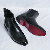 Men's black leather Chelsea boots with a sleek, formal design featuring slip-on ankle style and smooth finish.