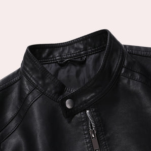 Men's black leather motorcycle jacket with a stylish zipper and button collar, featuring long sleeves and a sleek design.