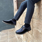 Men's black lightweight sneakers on a road surface, showcasing breathable mesh material and non-slip, shock-absorbing sole.