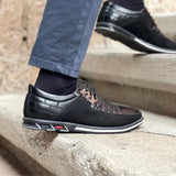 Men's black lightweight sneakers worn with jeans, showcasing breathable and non-slip features, suitable for everyday fashion and walking.