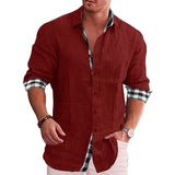 Men's black linen shirt with contrasting red cuffs, featuring roll-up sleeves and button-down collar, displayed on a mannequin model.