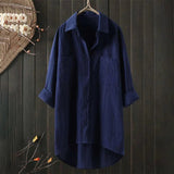 Men's marine blue linen shirt on a clothes hanger featuring a classic collar and long sleeves, displayed against a neutral background.