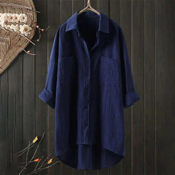 Men's marine blue linen shirt on a clothes hanger featuring a classic collar and long sleeves, displayed against a neutral background.