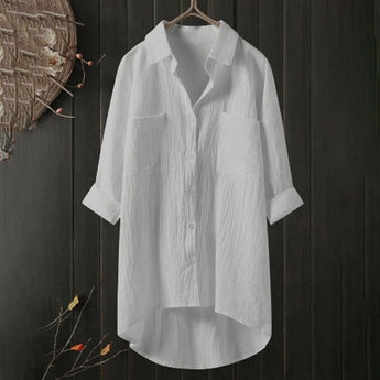 Men's black linen shirt on a clothes hanger, featuring long sleeves and a classic collar. The shirt is lightweight and breathable, designed in a simple yet stylish fashion with eco-friendly materials. Suitable for casual or semi-formal occasions.