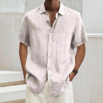 Men's black linen short sleeve summer shirt with a lightweight and breathable design, featuring a collar and button-up front, shown worn by a model.
