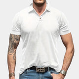 Men's black muscle-fit polo shirt with athletic stretch fabric, featuring short sleeves and a snug fit, highlighting arm muscles, worn by a model gesturing with their arm.
