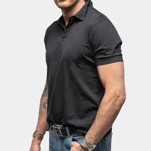 Men's black muscle-fit polo shirt made from athletic stretch fabric, featuring short sleeves, a collared neckline, and a tailored fit to accentuate muscle definition.