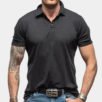 Men's black muscle-fit polo shirt made from athletic stretch fabric, featuring a short sleeve design and a classic collar, shown in size 2XL.