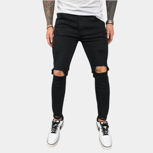 Men wearing black skinny jeans with ripped knees, styled for an urban street look.