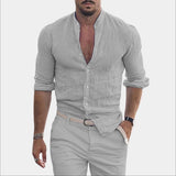 Men's black slim fit casual shirt featuring a textured V-neck design and rolled sleeves, modeled by a man with a beard wearing a gray variant in size 3XL, displaying a confident pose with his arms slightly bent, showcasing the shirt's fit and style.