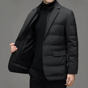 Men's black slim fit quilted blazer with a formal design, featuring a collar, long sleeves, and a waist-length cut suitable for winter wear.