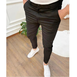 Man modeling men's black slim-fit tapered chinos, suitable for stylish office wear, in a size 2XL.