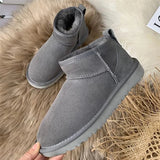Men's gray slip-on winter boots featuring a fleece lining for warmth, a non-slip sole for safety, and a durable design suitable for outdoor use.