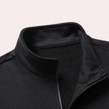 Men's black tracksuit set featuring long sleeves and a high collar, designed for winter sportswear and comfort. The outfit includes pockets for functionality and is made from composite materials.