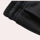 Men's black tracksuit set featuring a long sleeve design and a comfortable collar, suitable for winter weather and sports activities.