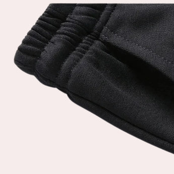 Men's black tracksuit set featuring a long sleeve design and a comfortable collar, suitable for winter weather and sports activities.
