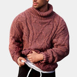 Men's black wool cable knit turtleneck sweater with a high collar, showcased on a model wearing headgear and a beard, highlighting the sweater's long sleeves and cozy winter fashion design.