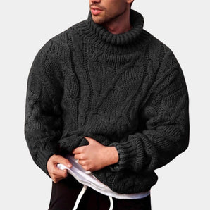 Men's black wool cable knit turtleneck sweater in XL size, featuring a cozy, textured design with long sleeves, shown being worn by a bearded model with a focus on the neck and upper body, highlighting winter fashion style.