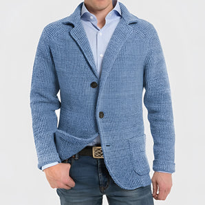 Men's blue knit blazer jacket with notch lapel, featuring a casual design crafted from wool, photographed against a neutral background.
