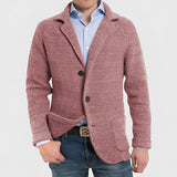 Men's blue knit blazer made of wool featuring a notch lapel, displayed on a hanger with a dress shirt underneath, showcasing its tailored sleeves and collar.