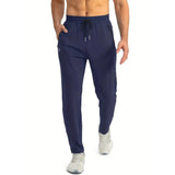 Men's marine blue quick-dry athletic shorts with zipper pockets, displayed on a person, showcasing the waist and knee length fit.