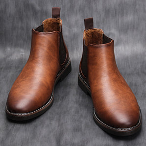 Men's brown leather Chelsea boots in a slip-on ankle design, showcased in a still life setting highlighting the durable material and fashionable style.