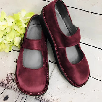 Men's brown suede slippers featuring an adjustable strap and non-slip sole, designed for comfort and casual wear.