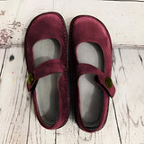 Men's brown suede slippers with an adjustable strap and non-slip synthetic rubber sole.