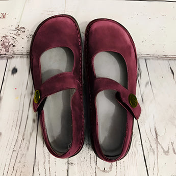 Men's brown suede slippers with an adjustable strap and non-slip synthetic rubber sole.