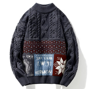 Men's cable knit ski sweater in dark gray, featuring a crewneck design with woolen texture, long sleeves, and intricate cable patterns.