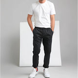Men's Casual Black Slim Fit Joggers with Elastic Waist in XL, showcased on a model wearing a grey t-shirt.
