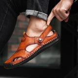Men's casual brown leather sandals displayed on a model's foot, showcasing the breathable, lightweight design and convenient slip-on feature.