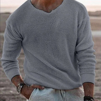 Men's casual white lightweight v-neck knit sweater worn by a bearded man.