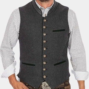 Men's charcoal grey slim fit wool vest in a formal vintage style, displayed on a hanger. The vest features a sleeveless design perfect for layering over a dress shirt. The fabric has a subtle grey tartan pattern, and the vest is tailored to fit snugly around the waist for a sleek appearance.