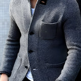 Men's charcoal tweed blazer in a slim fit design, featuring a wool herringbone pattern, shown in gray color, size 4XL. The model pairs it with a white dress shirt and is smiling.