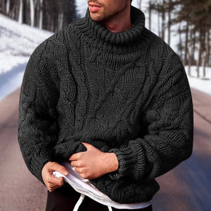 Men's chunky wool turtleneck sweater in black, size 3XL, worn by a bearded man in a snowy setting, showcasing the cozy winter fashion pullover with long sleeves and a stylish design.