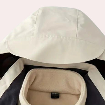 Men's color-block hooded windbreaker jacket in beige, featuring long sleeves and a stylish collar, displayed on a wooden surface.