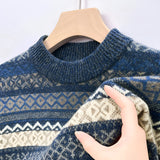 Men's blue woolen sweater featuring a Fair Isle pattern, with long sleeves and a ribbed collar. The sweater has a cozy and warm design suitable for winter wear.
